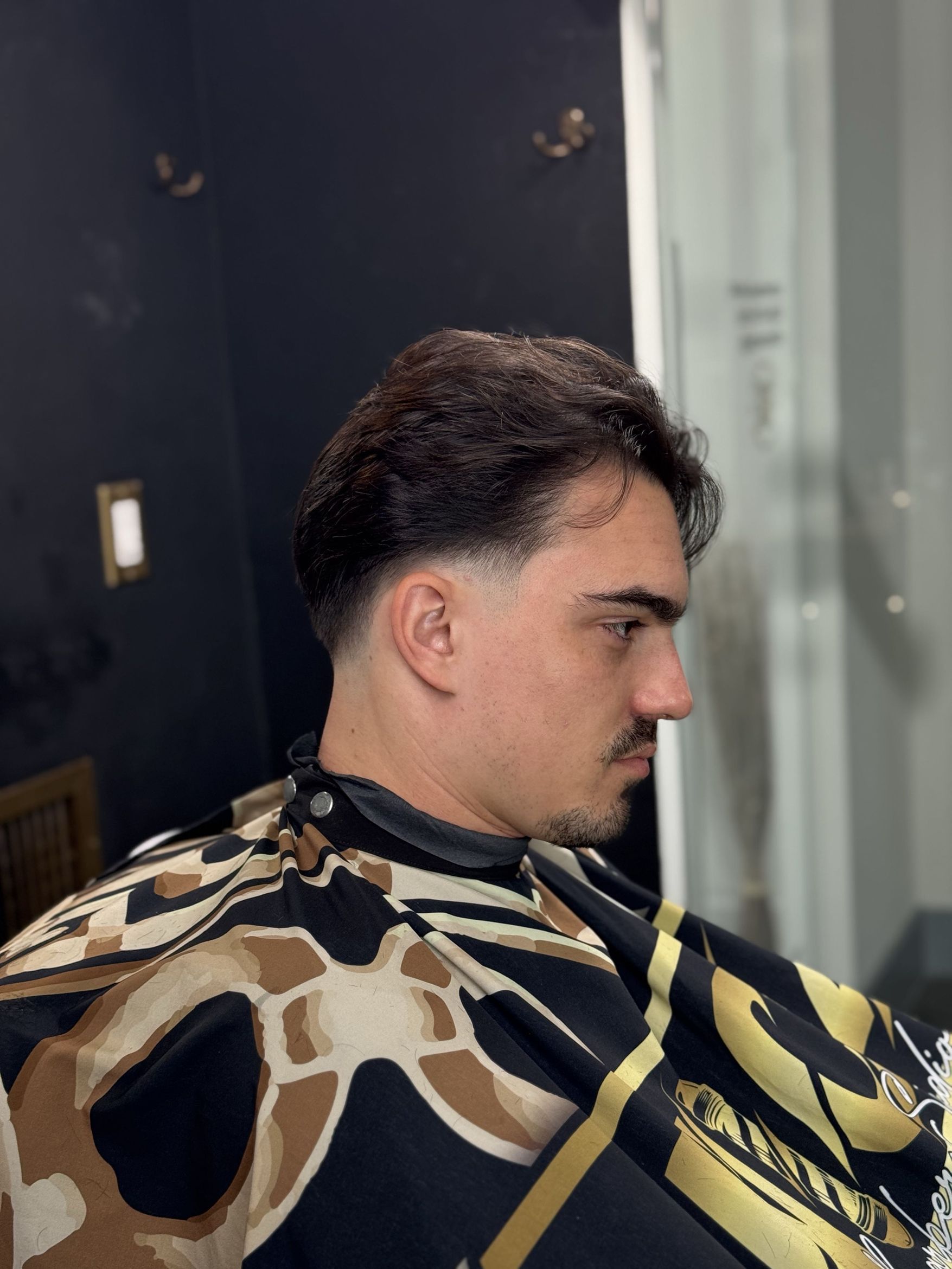 Low taper fade, side profile.